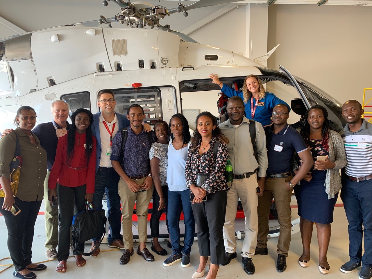 Group of people standing in front of a med flight helicopter