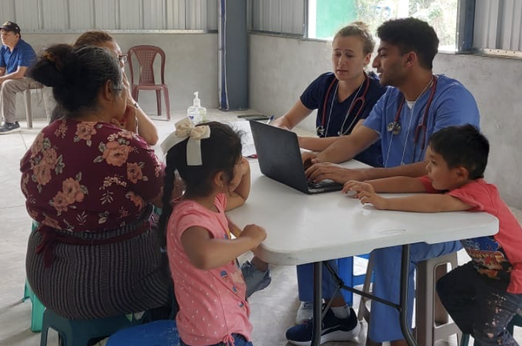 Students attending to patients under faculty supervision in clinics in the rural communities